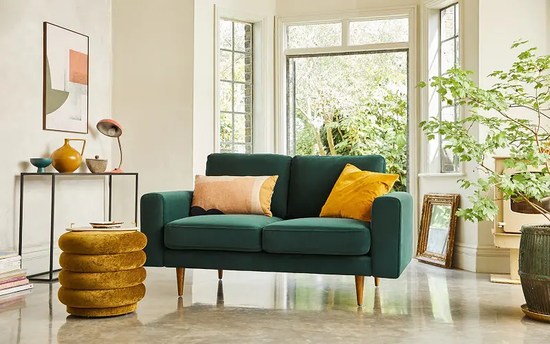 Forrest green sofa and mustard yellow decorations
