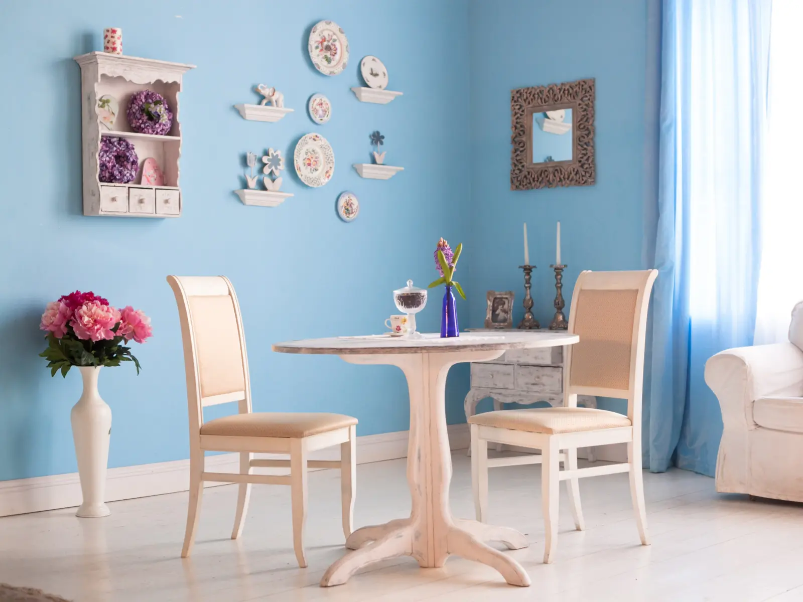Dining room with blue paint and old-style decorations for a piece on what colors go with light blue
