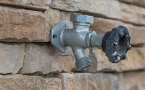 Image showing a hose bibb, one of the most common types of outdoor faucets, attached to a brick wall