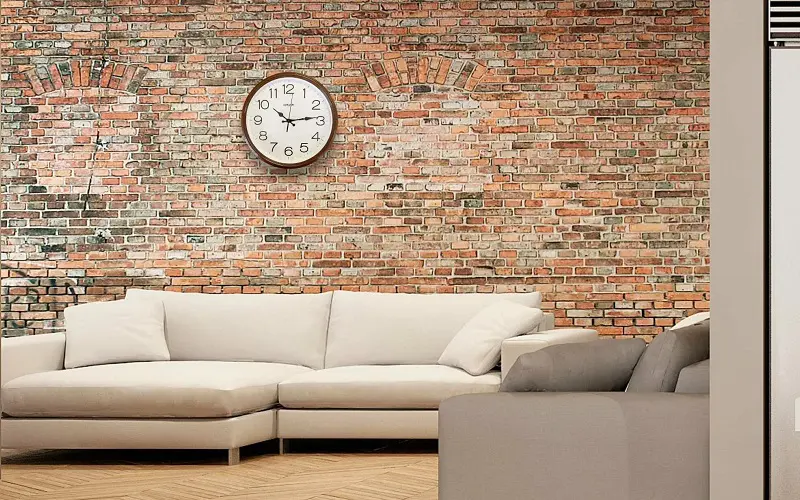 Living room with white sofa and brown brick wall