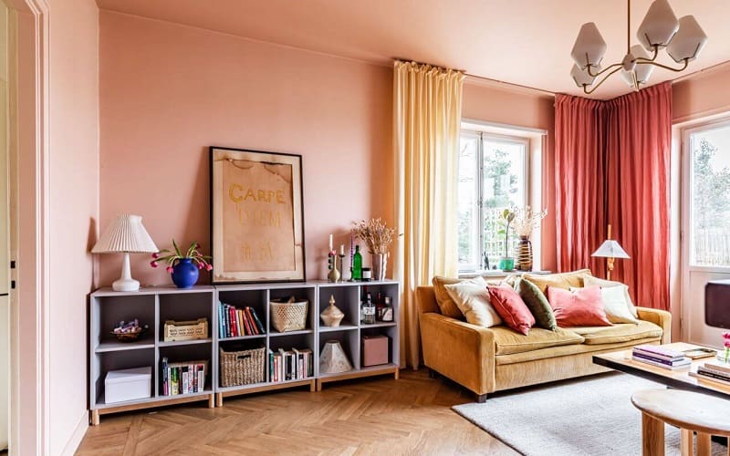 Scandinavian living room with mustard yellow soafa and pink curtains and decoration details