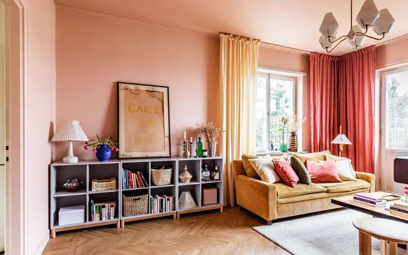 Scandinavian living room with mustard yellow soafa and pink curtains and decoration details
