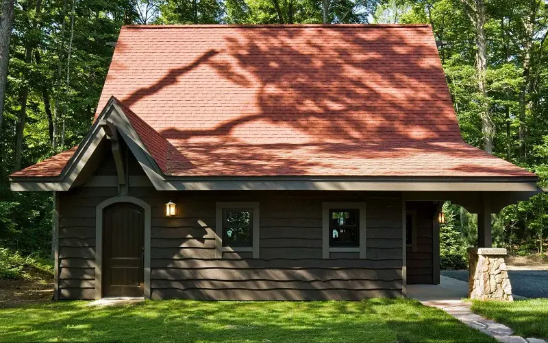 Wood cabin with red roof and brown exterior color