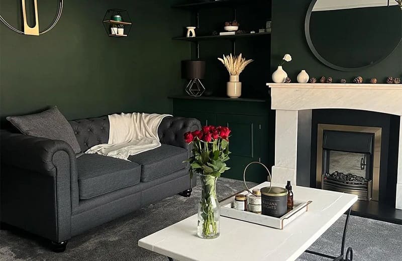 Dark green living room with dark grey sofa