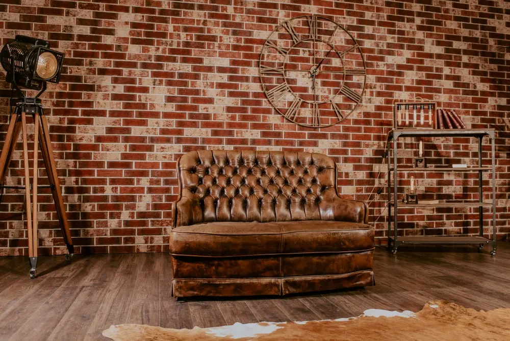 Image of several colors that go with brown brick featuring a dark brown chair and shelves
