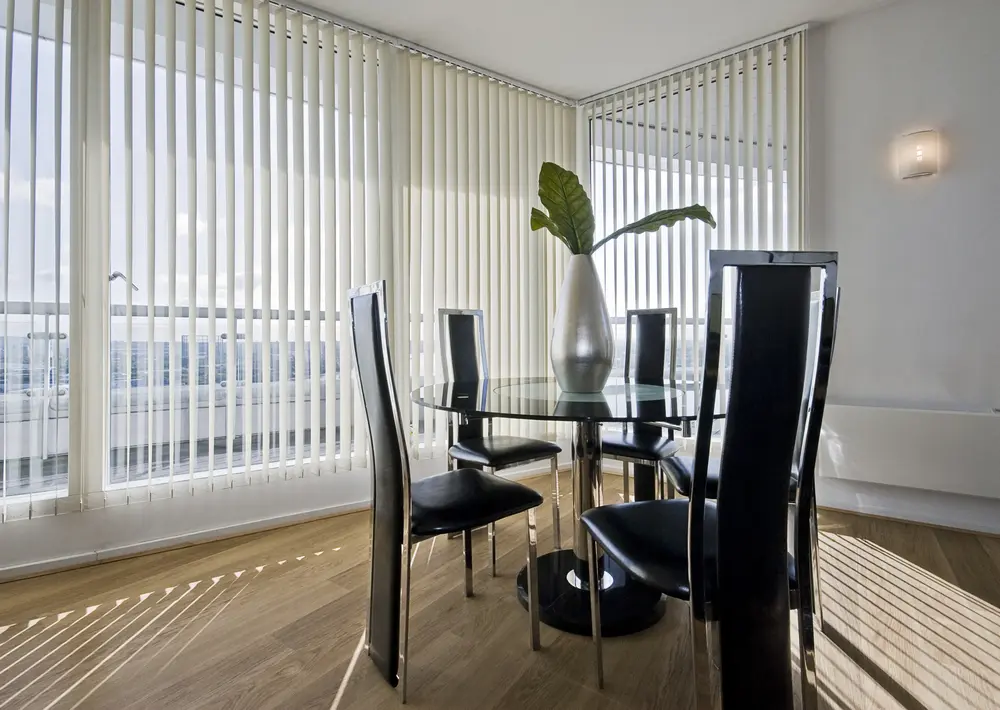 Stylish modern living room with vertical blinds, some of the most popular types of blinds