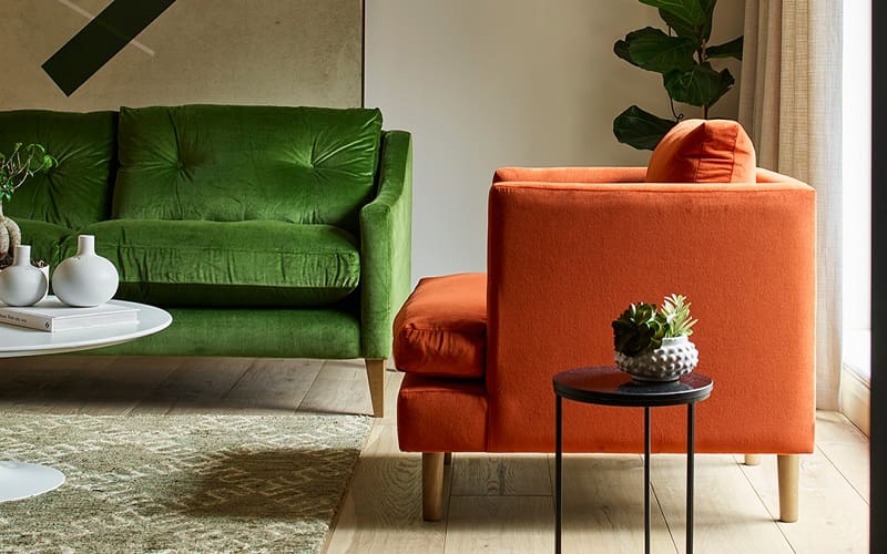 Forest green couch with burnt orange chair