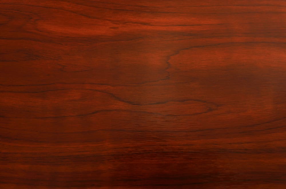 Cherry, a featured type of good grain pattern, in red wood in a close up image