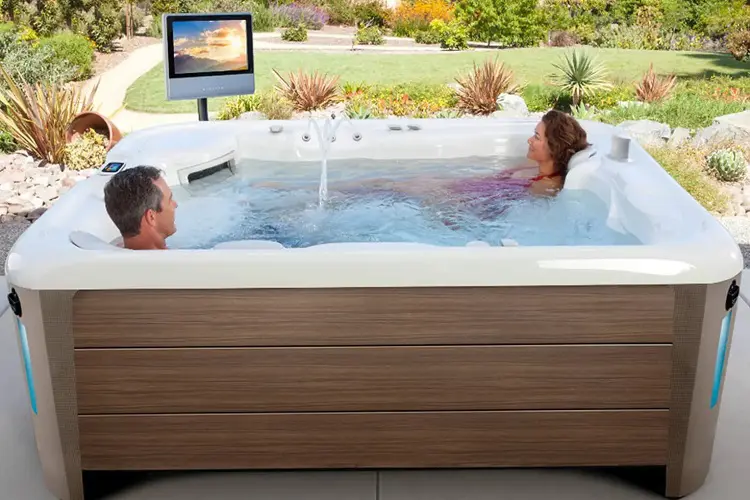 Happy couple relaxing in Hot Tub